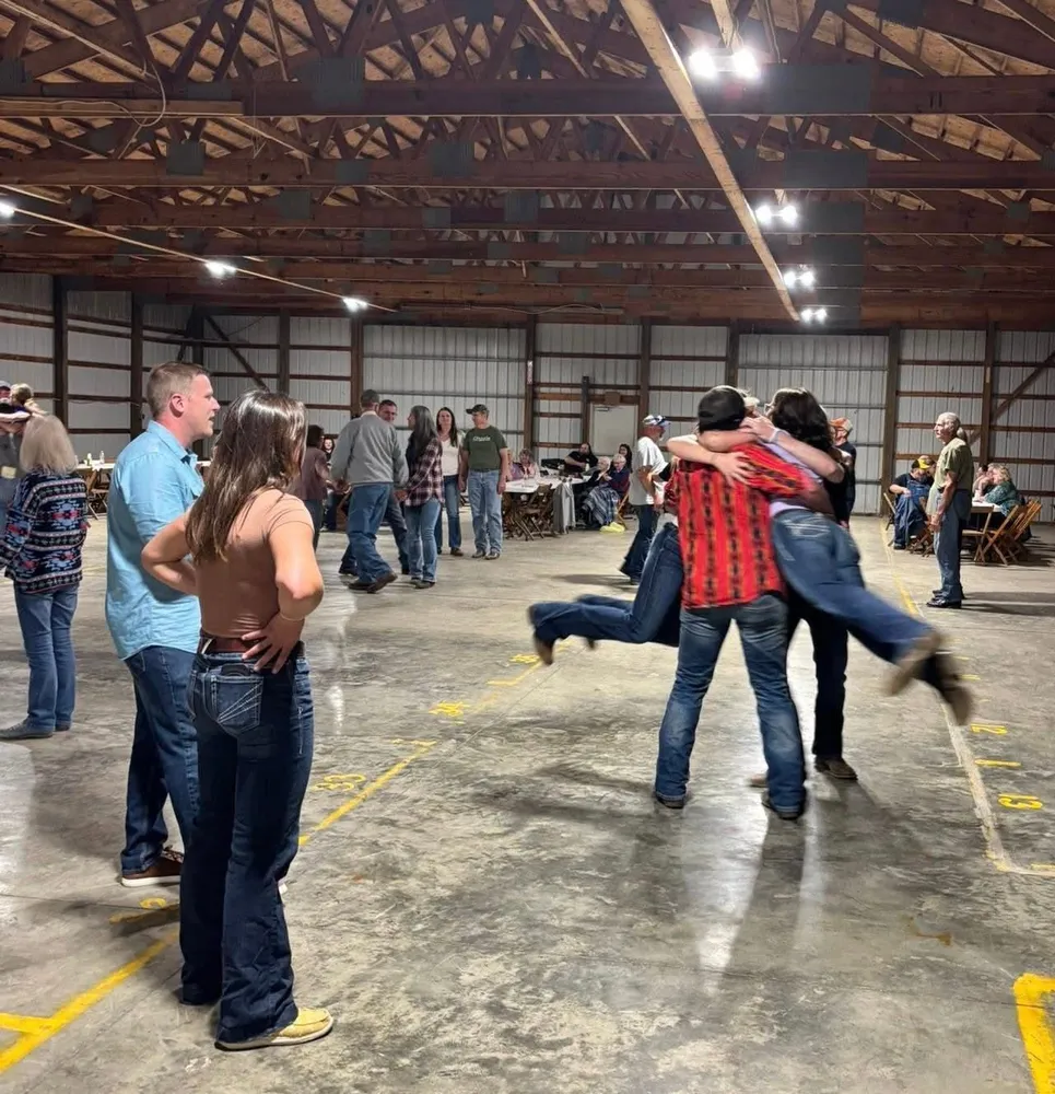 Friends dancing and hugging in the show barn